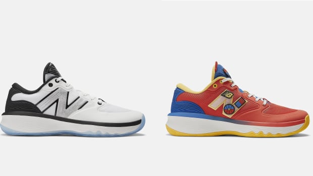 Side view of white and red New Balance sneakers.